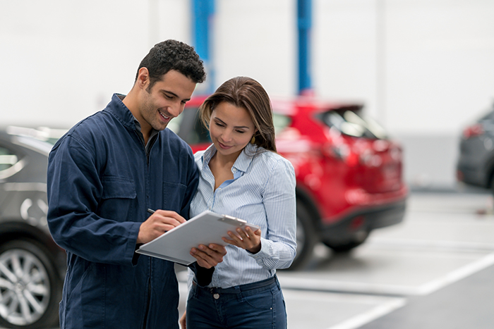 man and woman discussing car