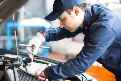 Mechanic underneath hood